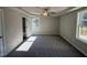 Spacious main bedroom features tray ceiling, ceiling fan, and access to rear deck at 175 Magnolia Run Way, Benson, NC 27504