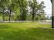 Backyard view with a large grass area, white brick retaining wall and white fence at 206 Ellington Rd, Graham, NC 27253
