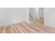 Spacious basement featuring wood-look flooring, stairs and neutral paint, creating a versatile living space at 206 Ellington Rd, Graham, NC 27253