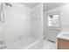 Bathroom featuring a white tiled bathtub with a shower head and sleek hardware at 206 Ellington Rd, Graham, NC 27253