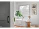 Bright bathroom featuring a modern tub next to a window, complemented by elegant decor and wood-look flooring at 206 Ellington Rd, Graham, NC 27253