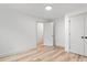 Spacious, light-filled bedroom with wood-look flooring, white walls, and two doors for easy access at 206 Ellington Rd, Graham, NC 27253