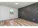 Bedroom boasting a decorative accent wall and light wood flooring at 206 Ellington Rd, Graham, NC 27253