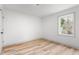 Cozy bedroom with light wood floors, neutral walls, and a window offering natural light at 206 Ellington Rd, Graham, NC 27253