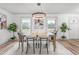Dining room features a wooden table, modern chairs, overhead lighting, and natural light at 206 Ellington Rd, Graham, NC 27253