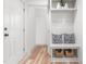 Welcoming entryway with a built-in bench, storage baskets, and white shiplap detailing at 206 Ellington Rd, Graham, NC 27253