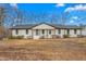 Charming renovated ranch-style home featuring a crisp white exterior and a newly installed roof at 206 Ellington Rd, Graham, NC 27253