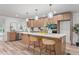 Open kitchen features an island with seating, modern appliances and light wood cabinets at 206 Ellington Rd, Graham, NC 27253