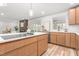 Bright kitchen with an island, stainless steel appliances, and open layout to the living area at 206 Ellington Rd, Graham, NC 27253