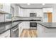 Bright kitchen featuring white cabinets and modern appliances at 206 Ellington Rd, Graham, NC 27253
