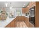 Well-lit kitchen featuring a large island with a cooktop, sleek cabinetry, and modern appliances at 206 Ellington Rd, Graham, NC 27253
