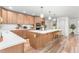 Bright kitchen boasts custom wood cabinetry, white countertops and an island with bar seating at 206 Ellington Rd, Graham, NC 27253