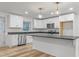 Modern kitchen features white cabinets, granite counters, and stainless steel appliances at 206 Ellington Rd, Graham, NC 27253