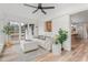 Bright living room featuring a neutral sofa, ottoman and light wood flooring at 206 Ellington Rd, Graham, NC 27253