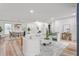 Spacious living room with white furniture, hardwood floors and modern decor offers a comfortable gathering space at 206 Ellington Rd, Graham, NC 27253