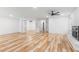 Spacious living room with wood floors, ceiling fan, and white painted brick fireplace at 206 Ellington Rd, Graham, NC 27253
