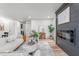 Cozy living room with a fireplace, plush seating, and hardwood floors, creating a warm and inviting atmosphere at 206 Ellington Rd, Graham, NC 27253