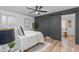Main bedroom boasts a barn door leading to the bathroom and a decorative accent wall at 206 Ellington Rd, Graham, NC 27253