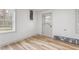 Bright room featuring wood-look flooring, neutral paint, a window, and a glass-paneled exterior door at 206 Ellington Rd, Graham, NC 27253