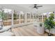 Bright sunroom with large windows offering serene outdoor views and stylish contemporary furnishings at 206 Ellington Rd, Graham, NC 27253