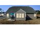 Home's back exterior with a well-maintained yard and an outdoor patio set at 25 Bourne Dr, Franklinton, NC 27525