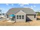 The house boasts a backyard with a patio with a grill and dining set under a bright blue umbrella at 25 Bourne Dr, Franklinton, NC 27525
