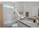 Bright bathroom with a tub and shower combination and a granite-topped vanity with a white sink at 25 Bourne Dr, Franklinton, NC 27525
