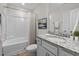 Well-lit bathroom featuring tub, shower, and a white vanity with granite countertop and sink at 25 Bourne Dr, Franklinton, NC 27525