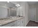 Bathroom featuring double sinks with granite counters and a large mirror with modern lighting at 25 Bourne Dr, Franklinton, NC 27525