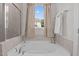 Bright bathroom with a soaking tub, shower, and window offering a glimpse of the outdoors at 25 Bourne Dr, Franklinton, NC 27525