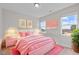 Bright bedroom features pink decor, natural light, and a comfortable atmosphere for rest and relaxation at 25 Bourne Dr, Franklinton, NC 27525