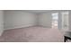 Spacious bonus room featuring neutral carpeting and fresh white trim and doors at 25 Bourne Dr, Franklinton, NC 27525