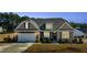 Charming home boasts stone accents, a two-car garage, and a cozy front porch at 25 Bourne Dr, Franklinton, NC 27525