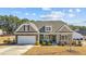 Beautifully landscaped two-story home with a two-car garage and a cozy front porch at 25 Bourne Dr, Franklinton, NC 27525