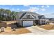 Charming home featuring a two-car garage, stone accents, and well-maintained landscaping at 25 Bourne Dr, Franklinton, NC 27525