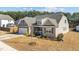 Charming single-Gathering home with a manicured lawn and inviting front porch seating at 25 Bourne Dr, Franklinton, NC 27525