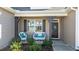 Cozy front porch with seating, decorative wreath, and well-maintained landscaping at 25 Bourne Dr, Franklinton, NC 27525