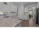 Bright kitchen with granite countertops, stainless steel sink, white cabinets, and eat-in breakfast area view at 25 Bourne Dr, Franklinton, NC 27525