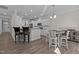 Open kitchen boasts white cabinets, stainless appliances, bar seating, and an adjacent dining area at 25 Bourne Dr, Franklinton, NC 27525