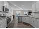 Bright, updated kitchen featuring stainless steel appliances, granite countertops, and white cabinetry at 25 Bourne Dr, Franklinton, NC 27525