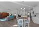 Open-concept living area flows into the kitchen and dining space with hardwood floors at 25 Bourne Dr, Franklinton, NC 27525