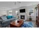 Comfortable living room features a fireplace, TV, blue accents, and lots of natural light at 25 Bourne Dr, Franklinton, NC 27525