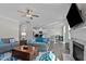 Open-concept living space features a fireplace, wood floors, and a view of the kitchen and dining area at 25 Bourne Dr, Franklinton, NC 27525