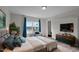 The main bedroom features a soft color palette and a large window overlooking a beautiful pool at 25 Bourne Dr, Franklinton, NC 27525