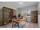 Well-lit home office with wooden desk, comfortable leather chair, and built-in shelving for ample storage at 25 Bourne Dr, Franklinton, NC 27525