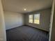 A bedroom featuring neutral walls, plush carpeting, and two windows allowing for ample natural light at 275 Magnolia Run Way, Benson, NC 27504