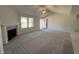 Bright living room features a fireplace, neutral carpet, ceiling fan, and plenty of natural light at 275 Magnolia Run Way, Benson, NC 27504