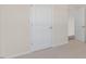 Neutral bedroom with carpet, white trim, and a doorway showing access to another room at 276 Hanging Elm Ln, Fuquay Varina, NC 27526