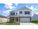 Charming two-story home featuring a brick and vinyl exterior, well-manicured lawn, and two car garage at 276 Hanging Elm Ln, Fuquay Varina, NC 27526