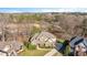 Aerial view of home with manicured lawn and landscape, long driveway, and tree lined perimeter at 2933 Elmfield St, Raleigh, NC 27614